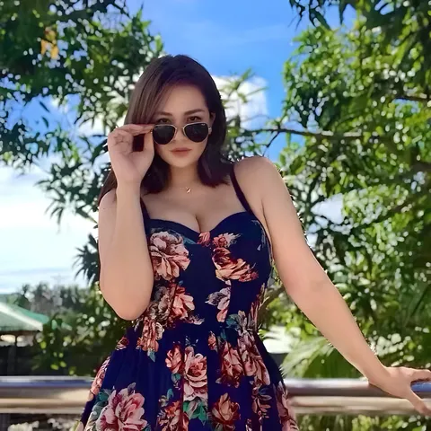 Roxell Tann in floral dress wearing sunglasses outdoors
