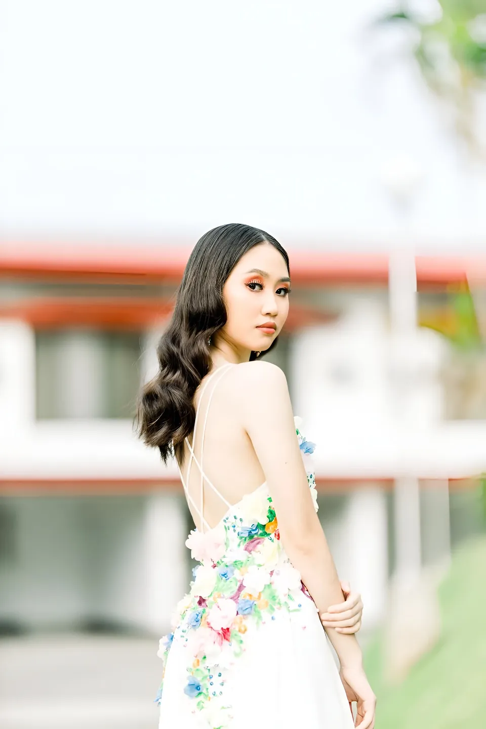 Stephanie Jean King in floral dress standing outdoors with blurred background