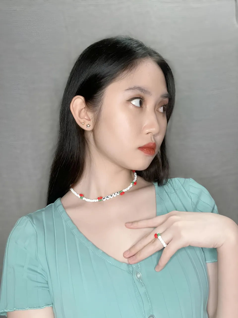 Stephanie Jean King wearing light blue top with beaded necklace and ring