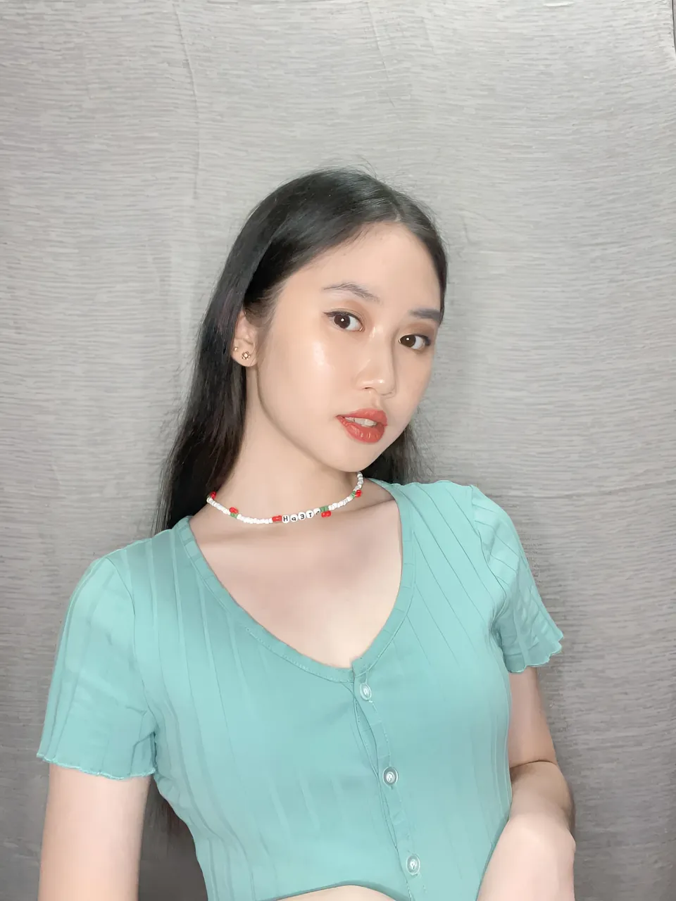 Stephanie Jean King wearing teal top with button front and beaded necklace