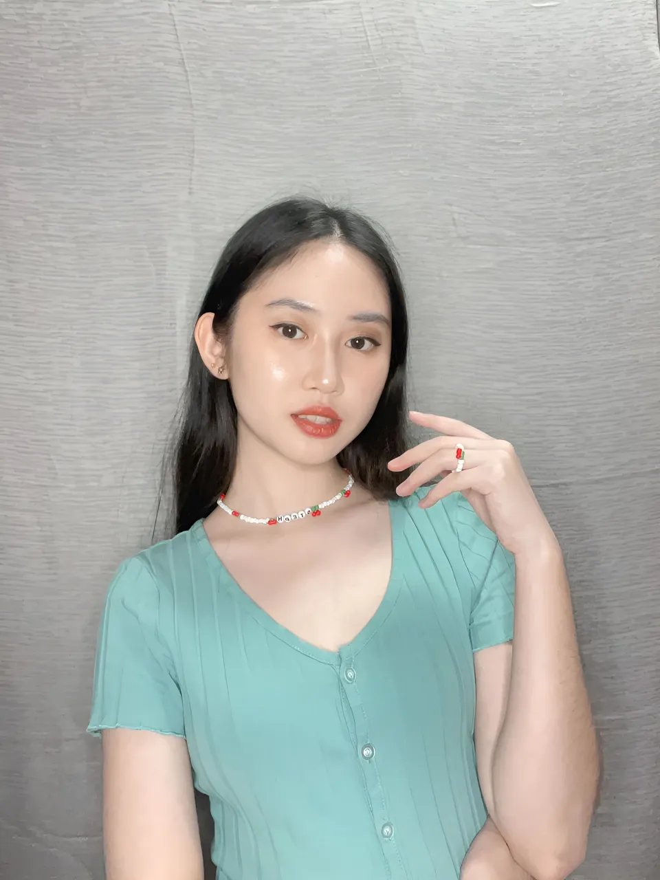 Stephanie Jean King wearing teal top with beaded choker and ring