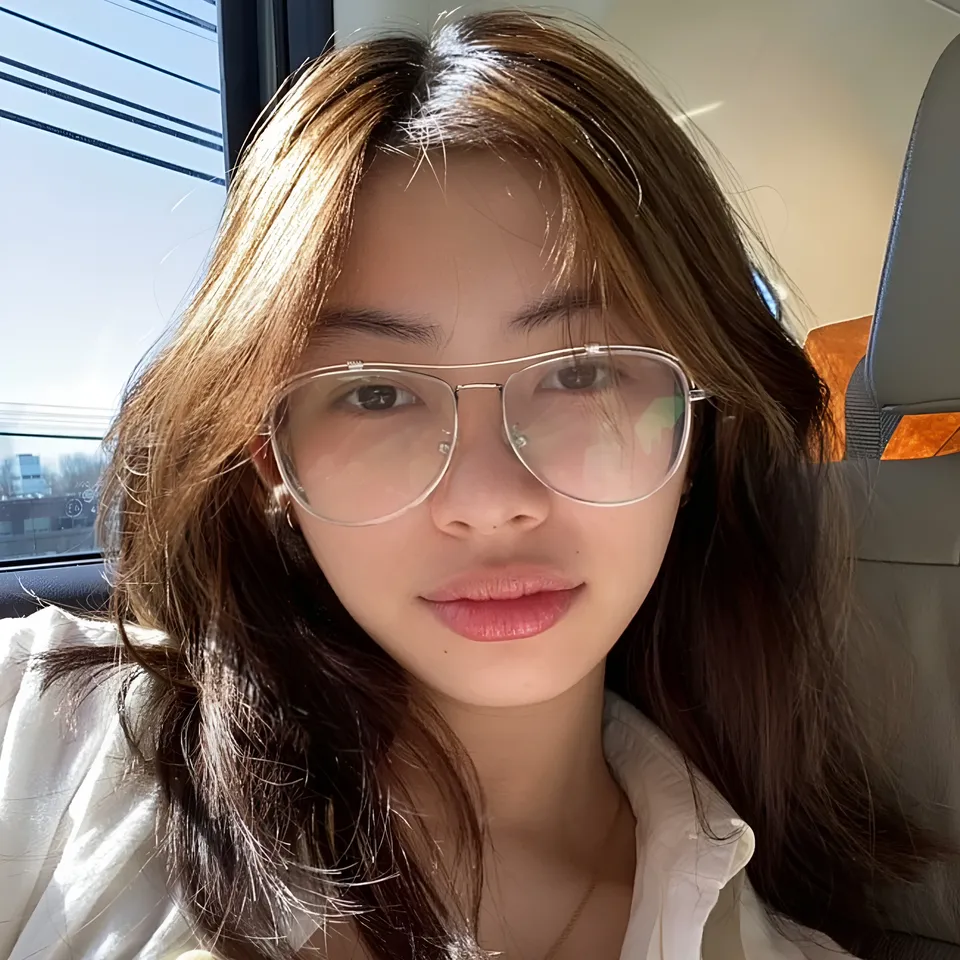 Thea Herrera wearing glasses seated in vehicle near window