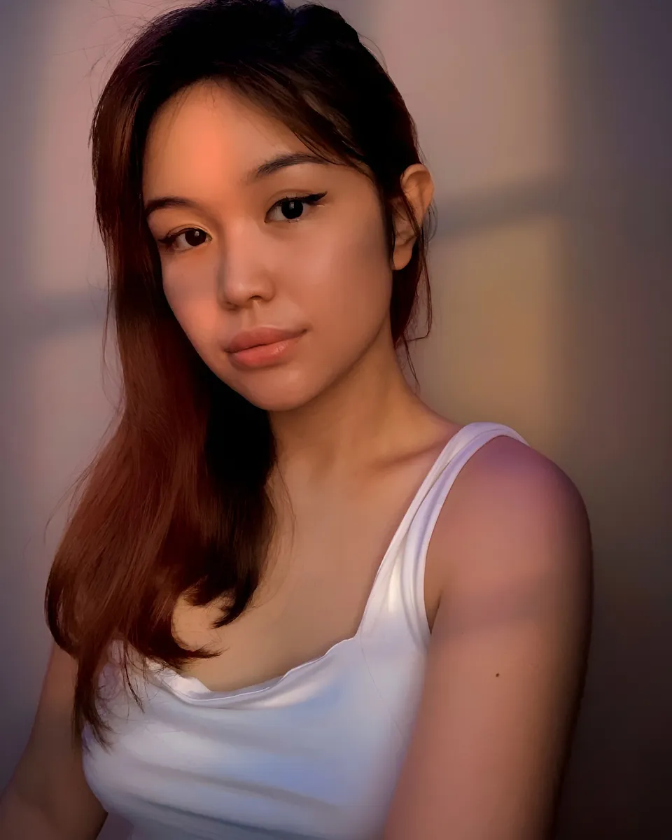 Trisha Catty Arroyo in white top, close-up portrait, soft lighting