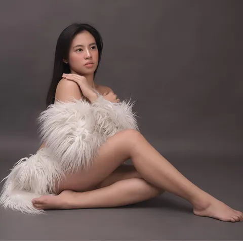 Zeanna Colleen seated with white fur draped over her lap